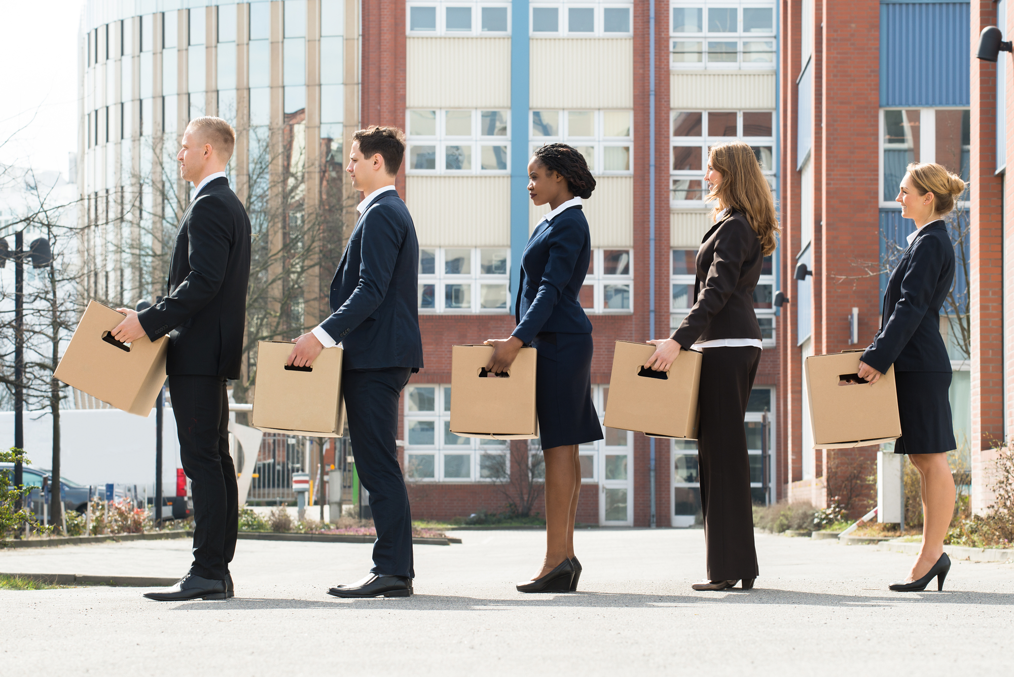 Business People Holding Boxes in a Line